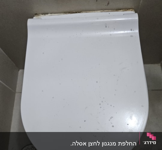 מכסה אסלה בחדר אמבטיה עם ריצוף